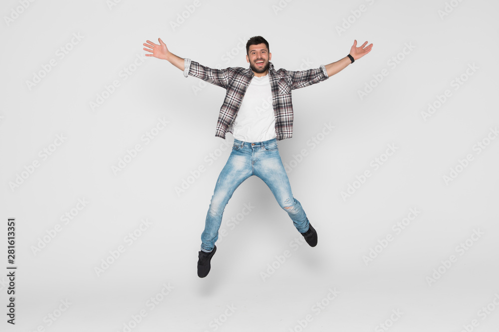 Handsome young man jumping isolated on white background Handsome young man jumping isolated on white background