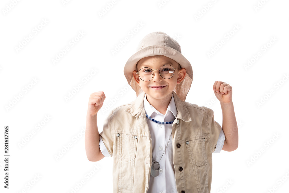 front view of smiling explorer boy in glasses and hat showing yes gesture isolated on white