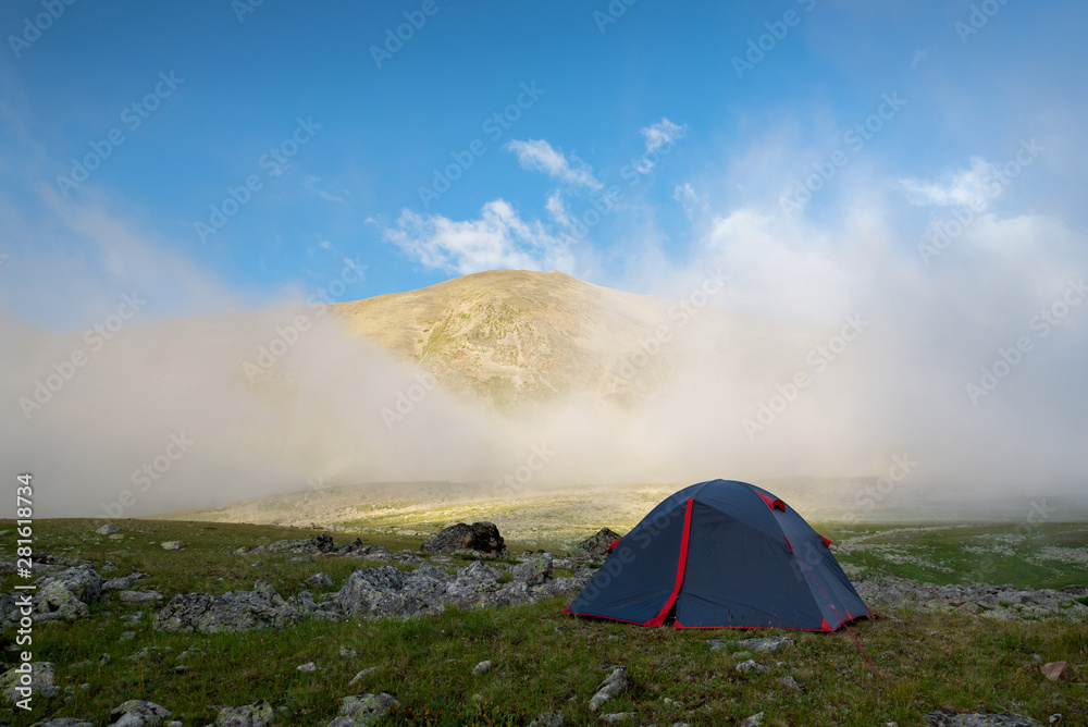 Tourist tent on a background of cloud or fog near the mountain Dzhalkaush, Teberda, Karachay-Cherkess Republic, Russia