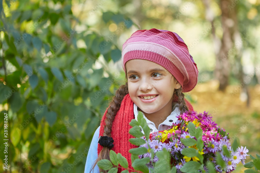 Beautiful happy girl in autumn park