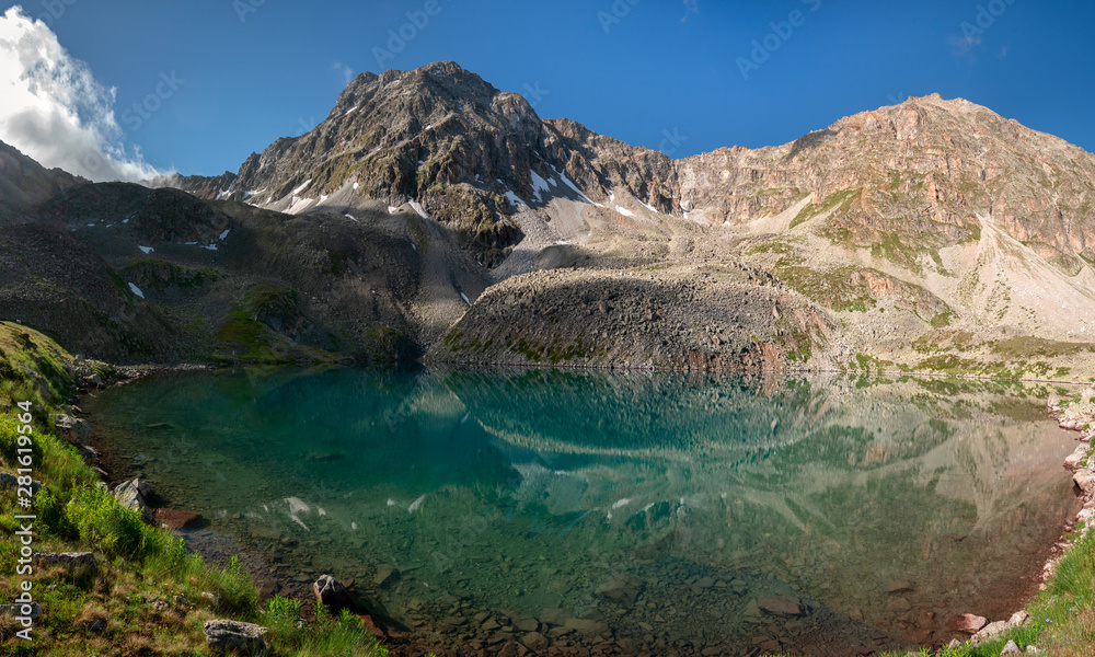 Fototapeta premium Alpine lake with clear water near the mountain Dzhalkaush, Teberda, Karachay-Cherkess Republic, Russia