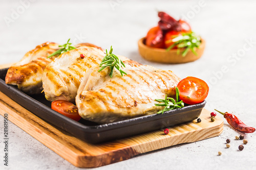 Stuffed grilled chicken breasts in cast iron skillet. Selective focus, copy space.