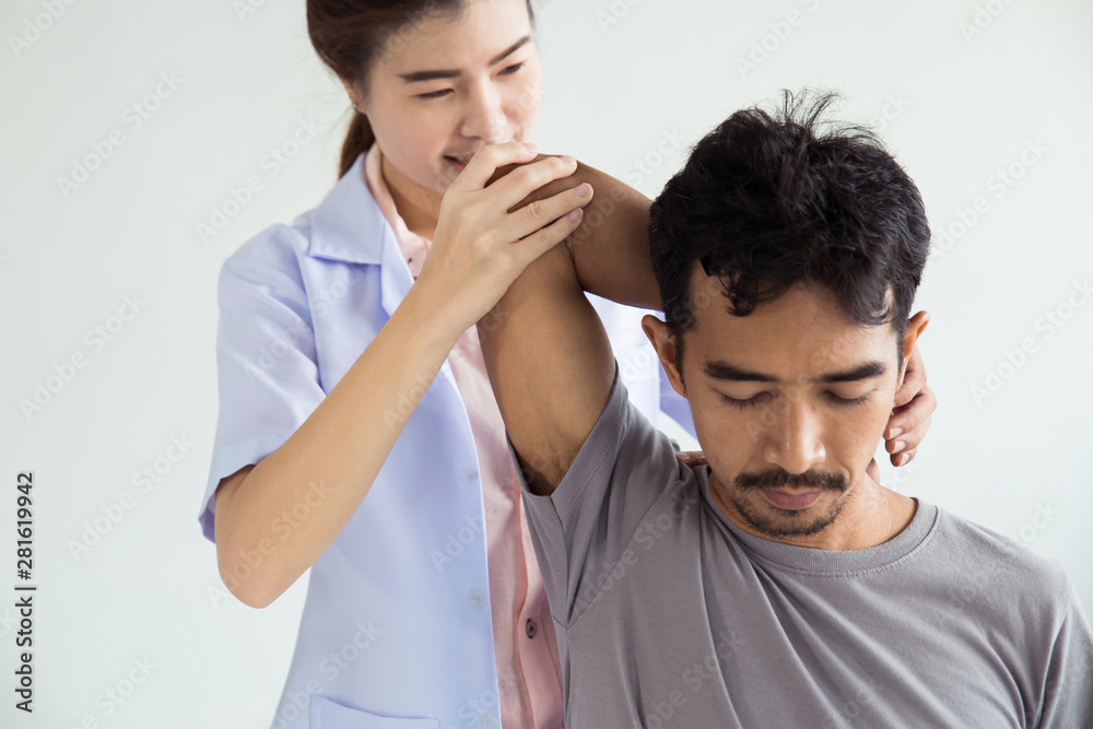 Professional female physiotherapist giving shoulder massage to man.physiotherapy, pain relief concept Professional female physiotherapist giving shoulder massage to man.physiotherapy, pain relief concept