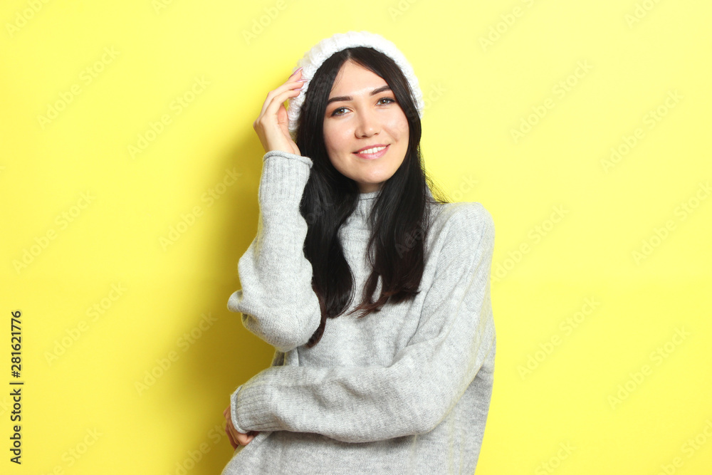 Beautiful girl in a warm cozy sweater on a colored background. Beautiful girl in a warm cozy sweater on a colored background.