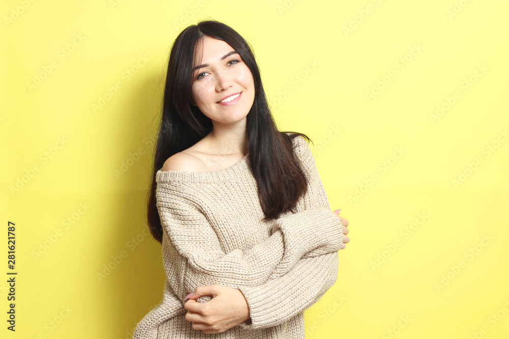 Beautiful girl in a warm cozy sweater on a colored background. Beautiful girl in a warm cozy sweater on a colored background.