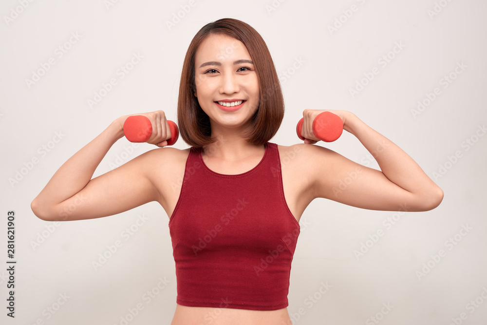 Woman is exercising with dumbbells Woman is exercising with dumbbells
