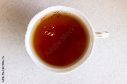 Cup of tea on a wood table, top view. A Cup of tea top view. Glass of tea top view on white surface