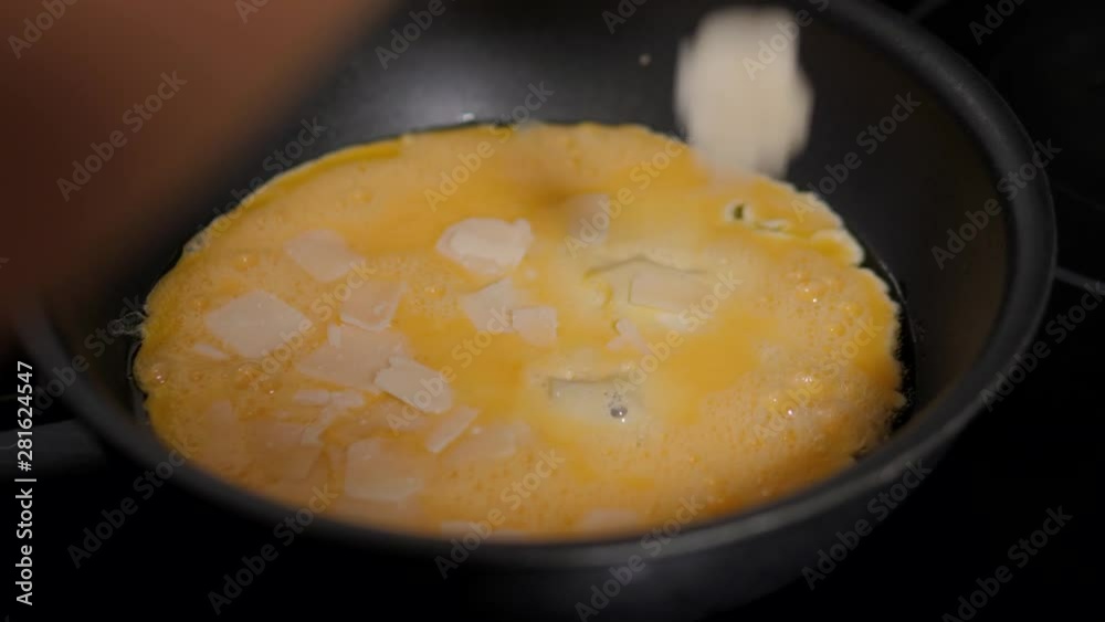 Woman hands breaking an egg to separate egg white and yolks and egg