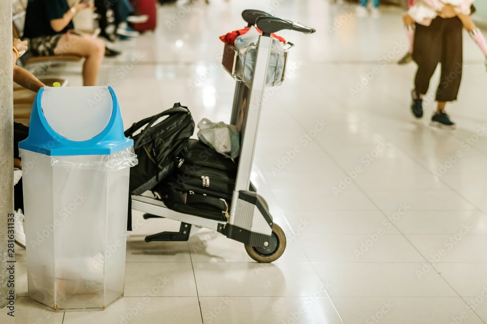 Fototapeta premium Blue cover transparent trashcan for increasing safety measures placed on the floor in the airport.