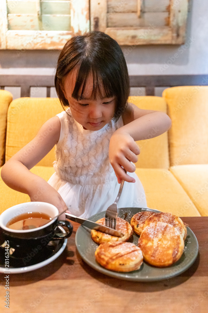 Asian Little Chinese Girl eating pancake