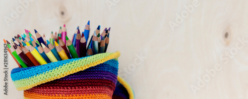 Colorful colored pencils ready to drawing on wooden background with copy space