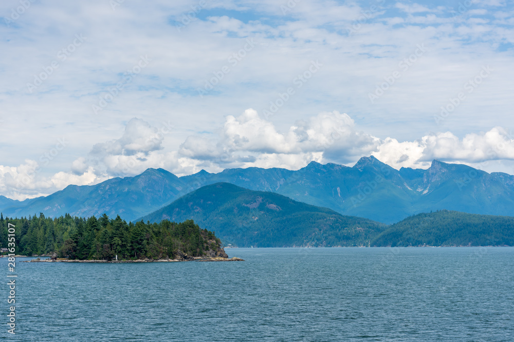 View at mountains in British Columbia, Canada.View over Inlet, ocean and island with mountains in beautiful British Columbia. Canada.