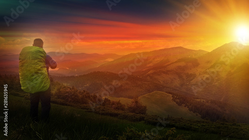 Autumn landscape with mountain, valley and lagoon views. The slopes of the hill are covered with scarlet arctous. Amazing sunset with sun rays over the mountains. photo