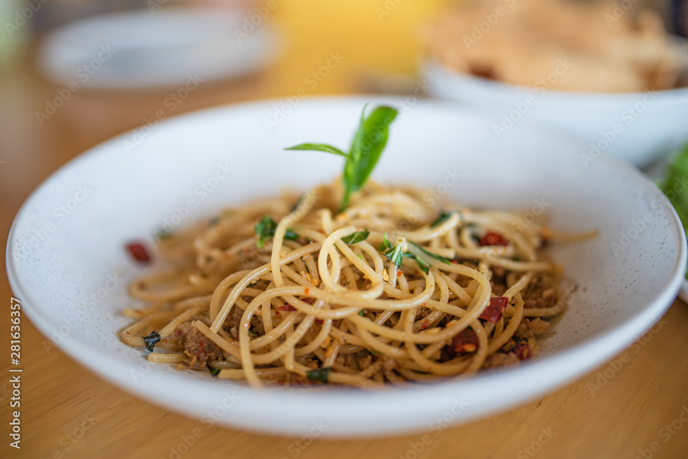 Spaghetti fried with basil and green tea in Thai fusion style