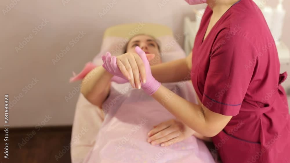 Portrait of a female cosmetologist in a protective mask and gloves while working with a client. Master shugaringa conducts the procedure of hair removal with sugar paste. Sugaring. Portrait of a female cosmetologist in a protective mask and gloves while working with a client. Master shugaringa conducts the procedure of hair removal with sugar paste. Sugaring.