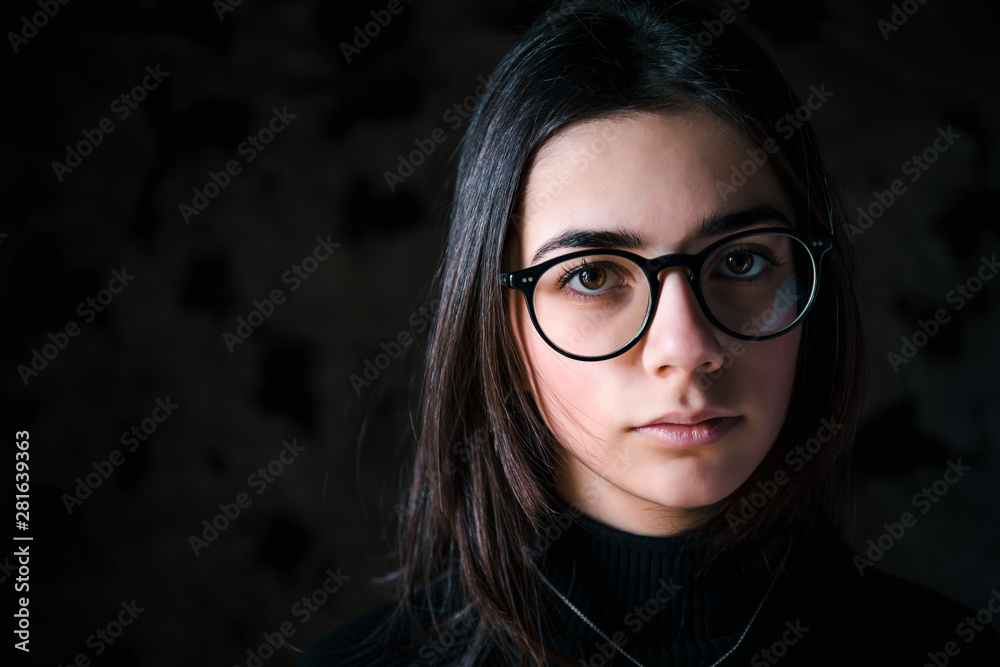 Close up face portrait of a young beautiful brunette girl looiking at camera Close up face portrait of a young beautiful brunette girl looiking at camera