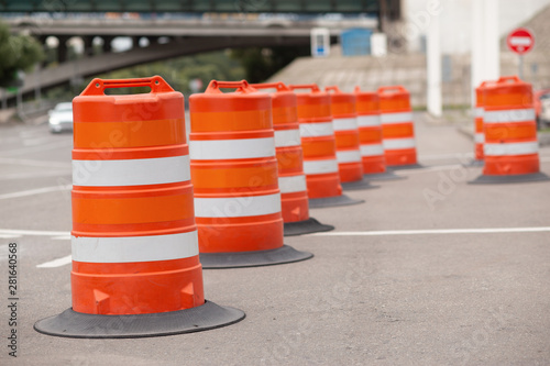 long line of orange traffic barrier barrels to detour traffic