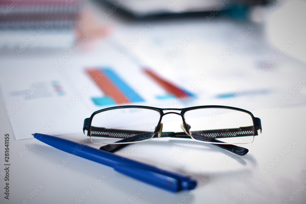 Group of multicolored office folders and glasses Group of multicolored office folders and glasses