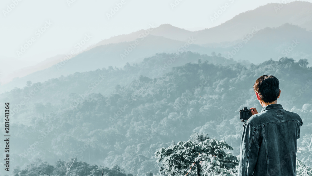 web banner and panorama of earth day and environment care travel concept from photographer man during take photo beautiful landscape of tropical forest with haze with soft focus of layer mountain web banner and panorama of earth day and environment care travel concept from photographer man during take photo beautiful landscape of tropical forest with haze with soft focus of layer mountain