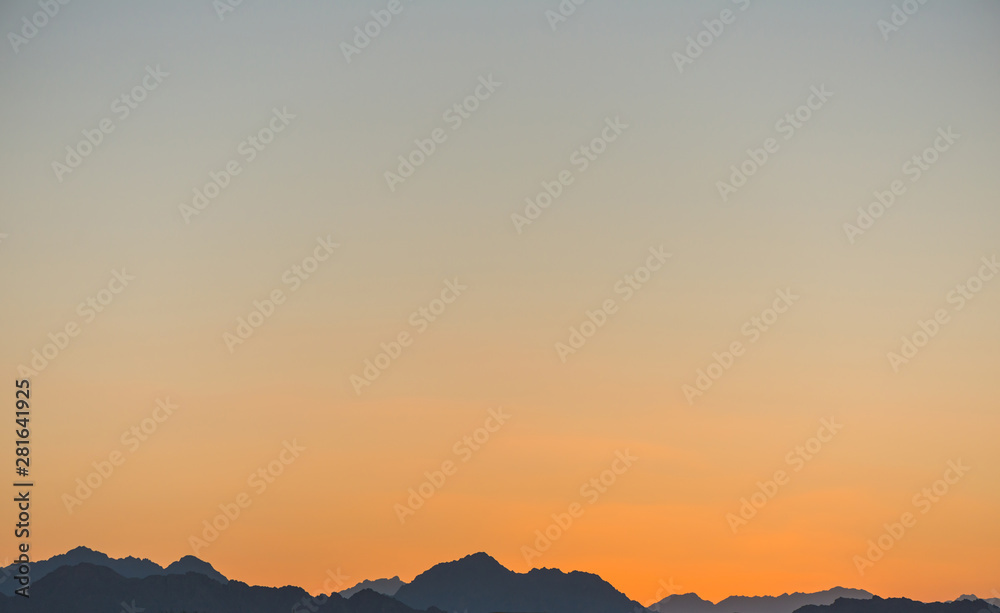 horizon line over mountains at summer sunset