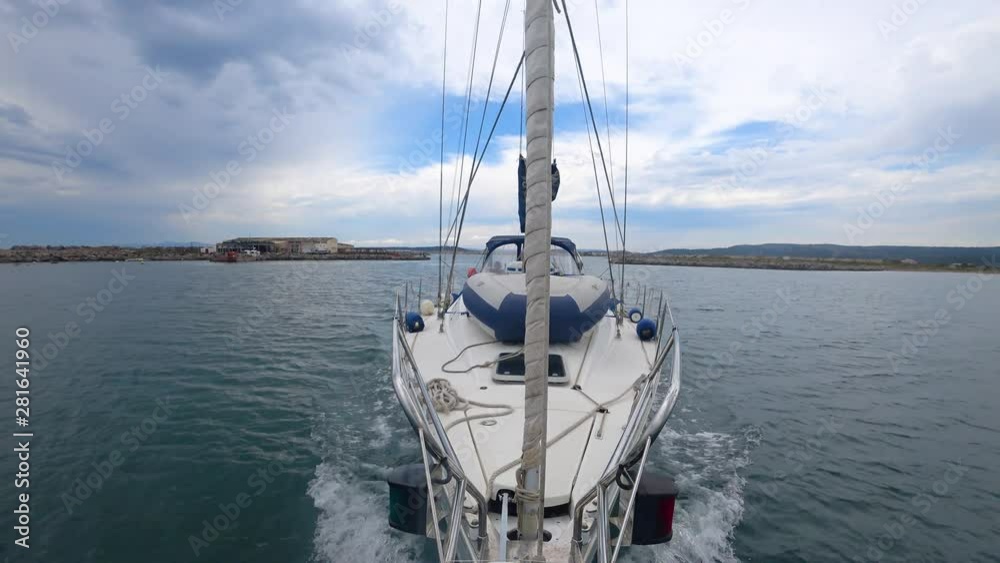 yacht sailing on a motor without sails; view from the bow to the yacht yacht sailing on a motor without sails; view from the bow to the yacht