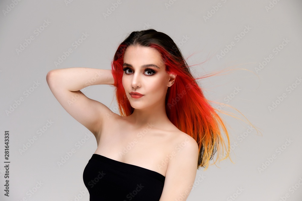 Studio portrait of a model with perfect makeup and colored hair on a white background. Beautiful female face of a pretty girl. Perfect makeup. Skin care. Fashionable cosmetics. Studio portrait of a model with perfect makeup and colored hair on a white background. Beautiful female face of a pretty girl. Perfect makeup. Skin care. Fashionable cosmetics.