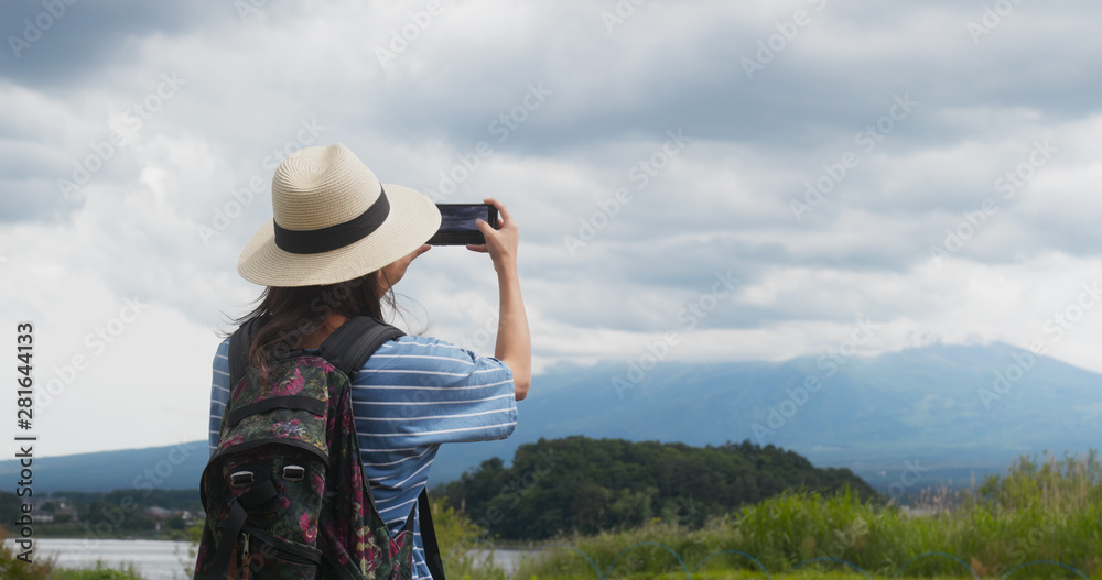 Woman take photo on the mountain