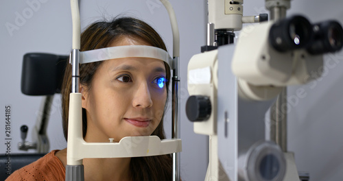 Woman undergo checking eye in clinic