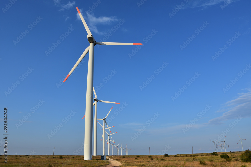 Fototapeta premium Wind generators in the fields near Kaliakra Cape, Bulgaria. Renewable energy. Sustainable energy resource