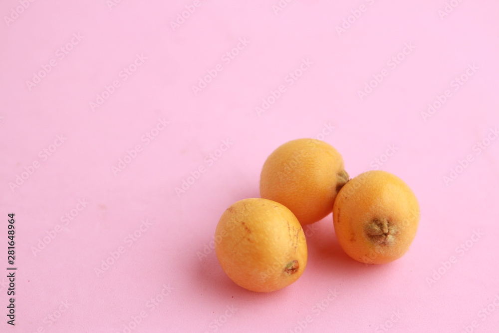 delicious yellow medlar fruit with colorful background