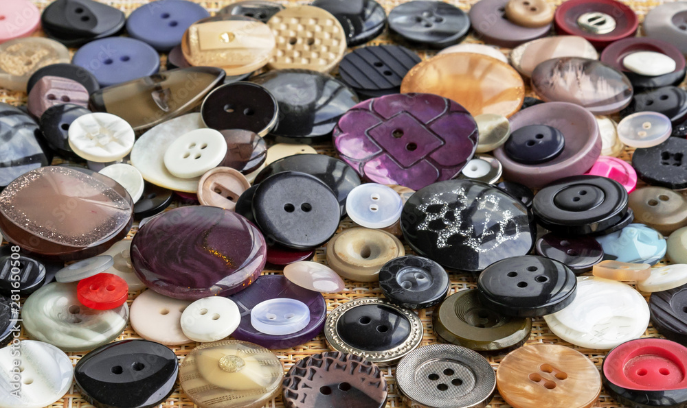 Background of buttons for clothes. Buttons of different shapes and sizes. Background of buttons for clothes. Buttons of different shapes and sizes.
