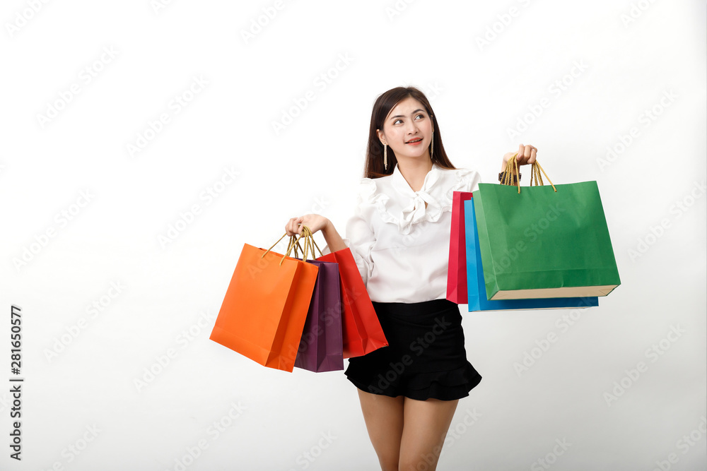 Portrait of an excited beautiful woman holding shopping bags isolated on white.