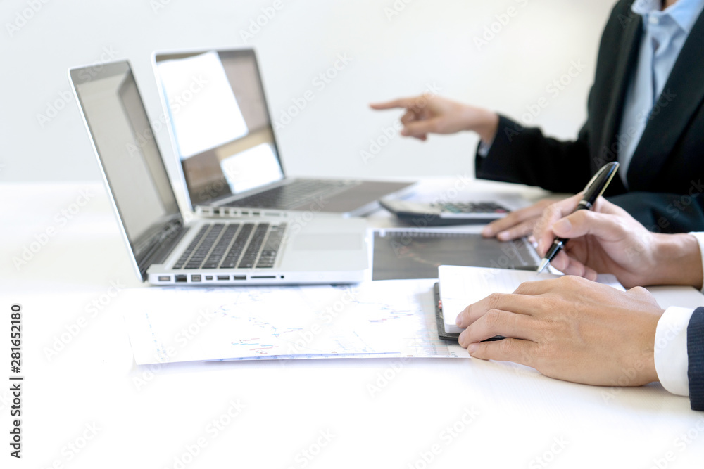business man and woman sit at ther table looking at computer laptop business man and woman sit at ther table looking at computer laptop