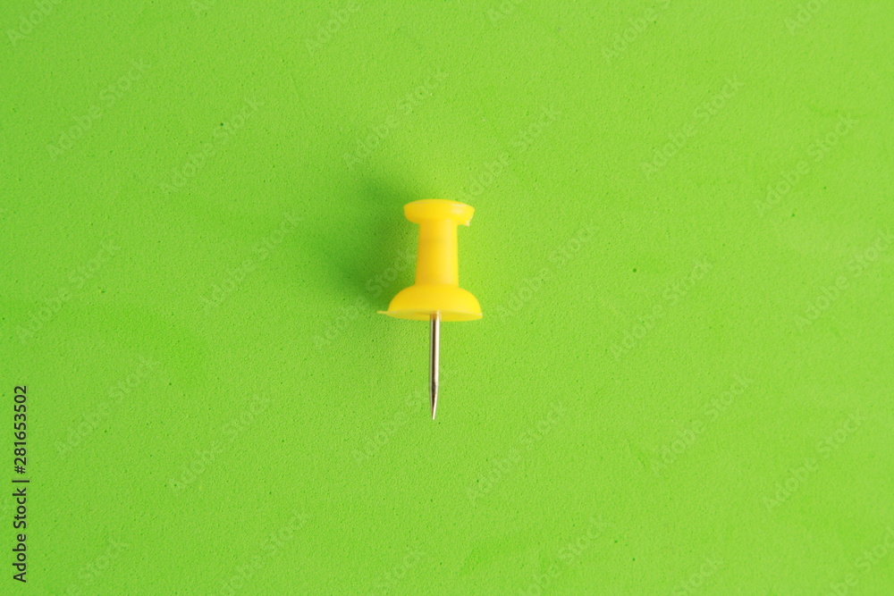 plastic thumbtacks in colorful background