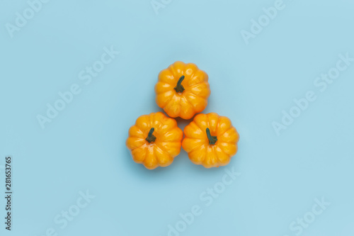Pumpkins on pastel blue background. Flat lay, top view fall autumn and Halloween concept.