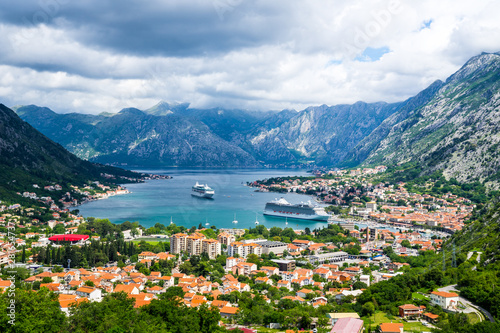 Montenegro, Famous bay of kotor city houses, waterside and harbor with two cruise ships surrounded by mountains nature landscape