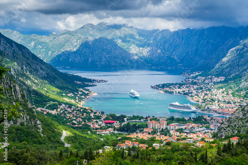 Montenegro  Bay of kotor city with many houses  waterside and harbor with two cruise ships inside pretty mountains nature landscape