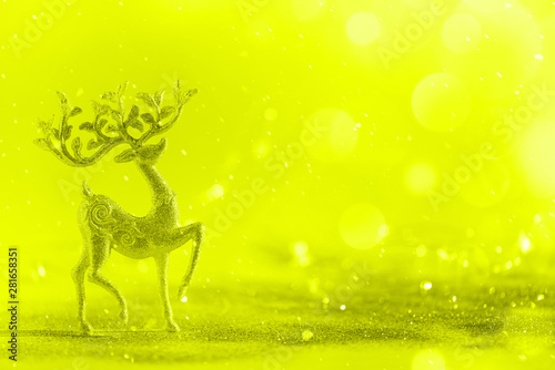 Silver glitter Christmas deer on neon yellow background with lights bokeh  copy space. Greeting card for new year party. Festive holiday concept. Banner