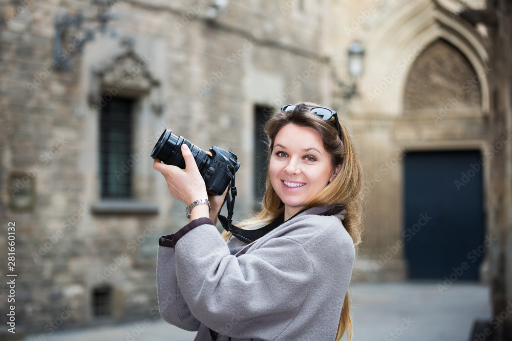 Girl holding camera and photographing