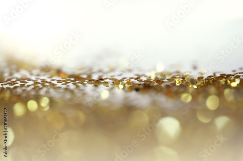 Gold (bronze) glitter shine dots confetti. Abstract light blink sparkle defocus backgound.