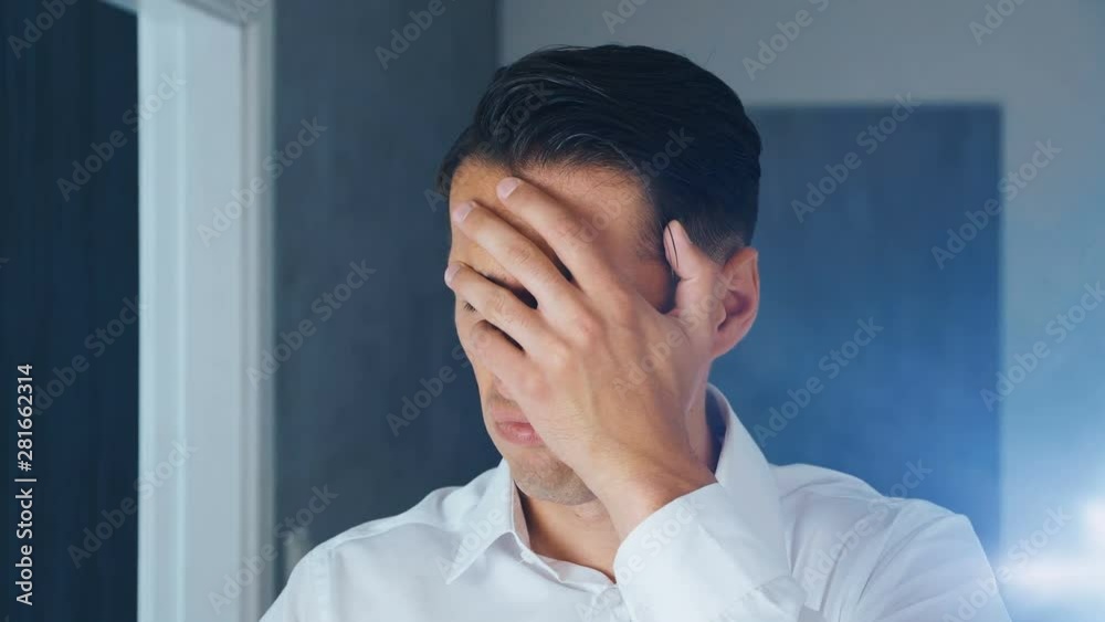 Portrait of shocked and disgusted man. Confused man saw an unpleasant message on a smartphone. He is worried about seeing. Close-up.