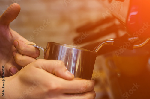 Barista making coffee with coffee machine in cafe