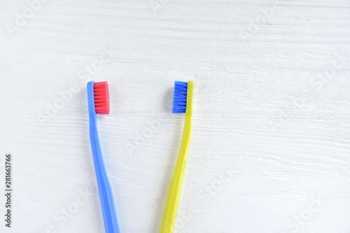 Two bright toothbrushes with soft focus on blurred neutral background. Plastic toothbrush for personal daily oral hygiene. Dental healthcare. Tools for morning routine. Caries protection