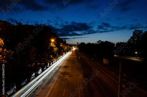 Nightscape car moving light trail long exposure photography in a city landscape during the night time with cloud movement