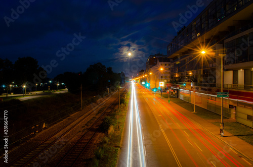 Nightscape parallel road and rail track and car moving light trail long exposure photography in a city landscape during the night time