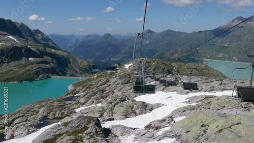 POV travelling on chairlift over of Weissee and Tauernmoosee alpine lakes in Uttendorf, Salzburger Land, Austria. photo