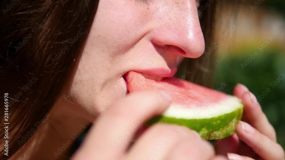 Smiling woman eating watermelon in slow motion. Happy summer time. Female emotion at summer vacation. Female tourist eating tasty summer fruit Smiling woman eating watermelon in slow motion. Happy summer time. Female emotion at summer vacation. Female tourist eating tasty summer fruit