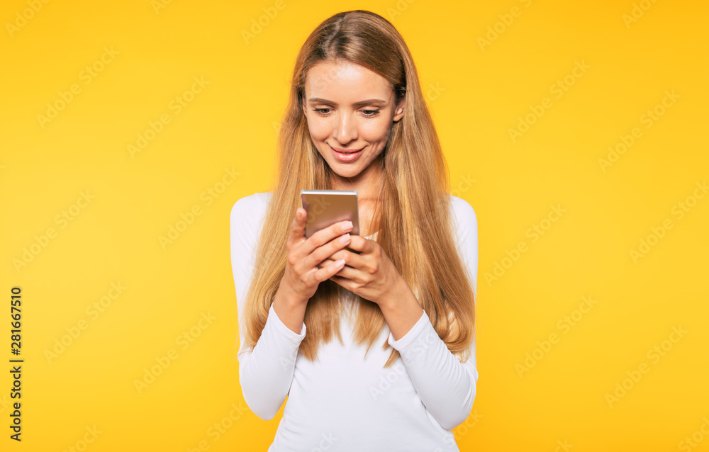 Blonde cute and lovely young woman is using her smart phone. Chatting with friend Blonde cute and lovely young woman is using her smart phone. Chatting with friend