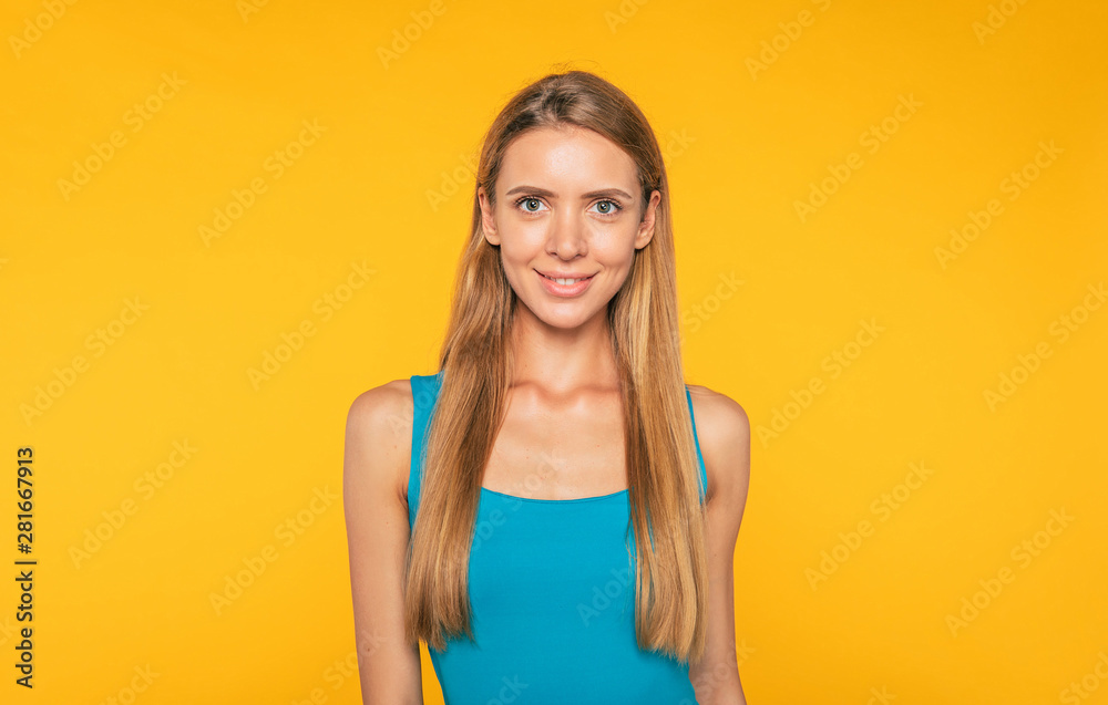 Portrait of beautiful blonde young woman in casual clothes. Confident cute girl is posing over yellow wall. Style and fashion. Beauty and healthcare. Women life Portrait of beautiful blonde young woman in casual clothes. Confident cute girl is posing over yellow wall. Style and fashion. Beauty and healthcare. Women life
