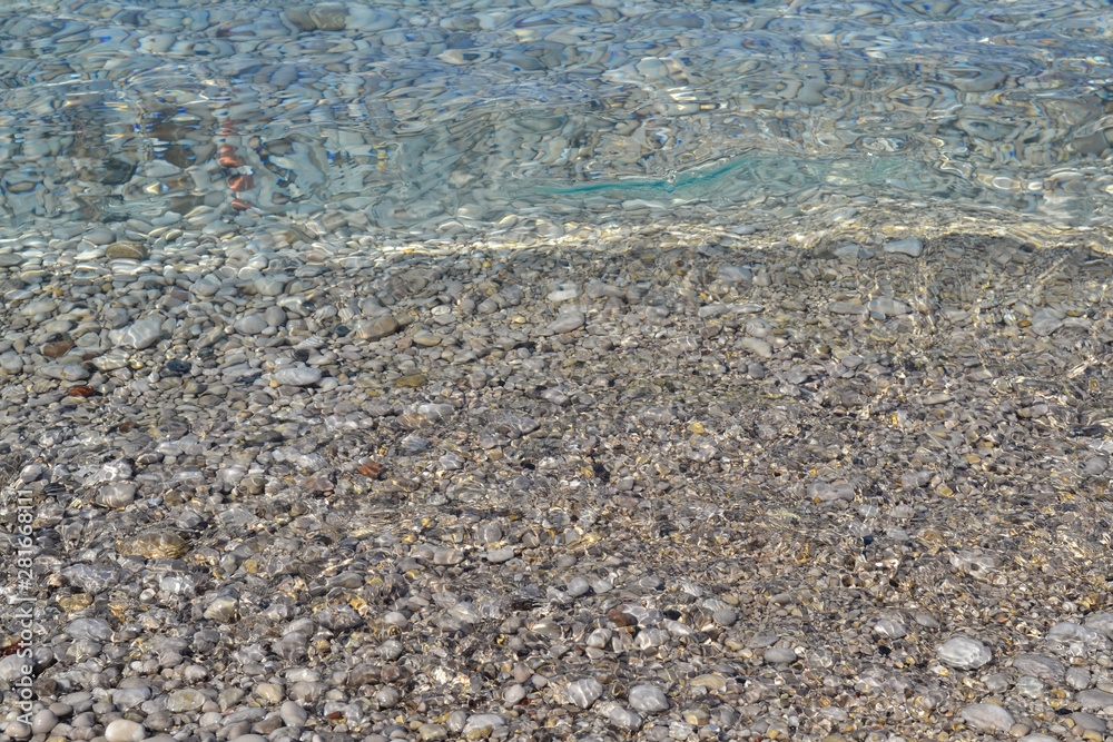 Abstract beach background texture with pebbles, sands and sea water in bodrum turkey Abstract beach background texture with pebbles, sands and sea water in bodrum turkey